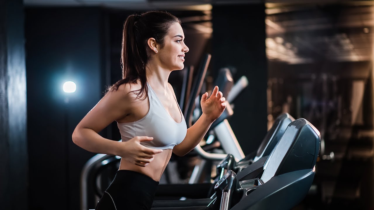 Modern hotel gym with cardio machines and free weight area
